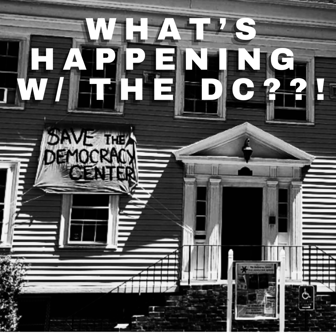 photo of a house with a banner hanging from a window that is painted with the words 'SAVE THE DEMOCRACY CENTER' - computer text over photo (bold and white) says 'WHAT'S HAPPENING WITH THE DC?'